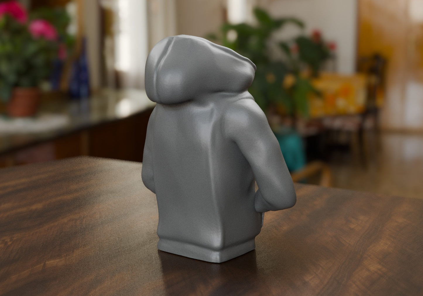 a grey lego figure sitting on top of a wooden table