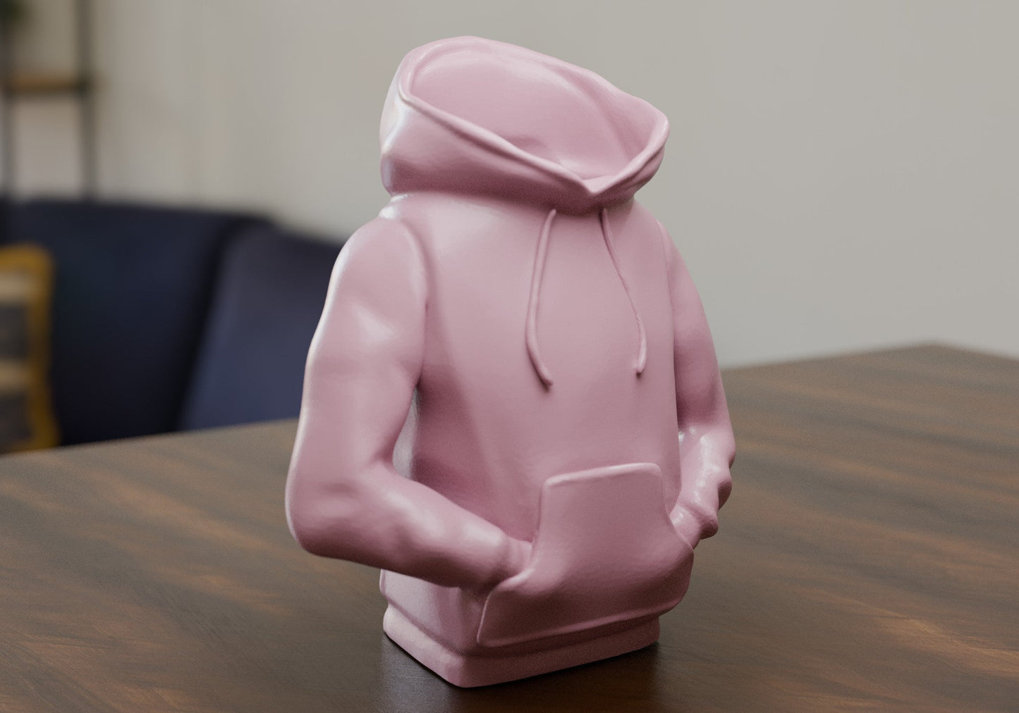 a pink statue of a person sitting at a table