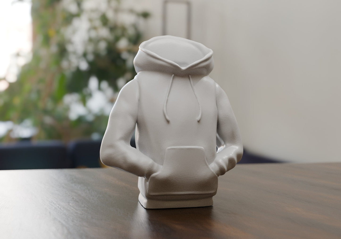 a white statue of a person sitting on a table