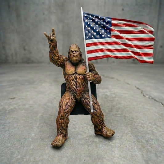 A figurine of a large, furry creature holding an American flag.