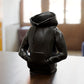 a black toy sitting on top of a wooden table