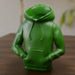 a green toy sitting on top of a wooden table