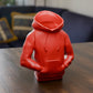 a red toy sitting on top of a wooden table