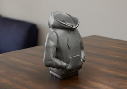 a statue of a person sitting on a table