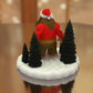 a figurine of a man in a santa hat on a table