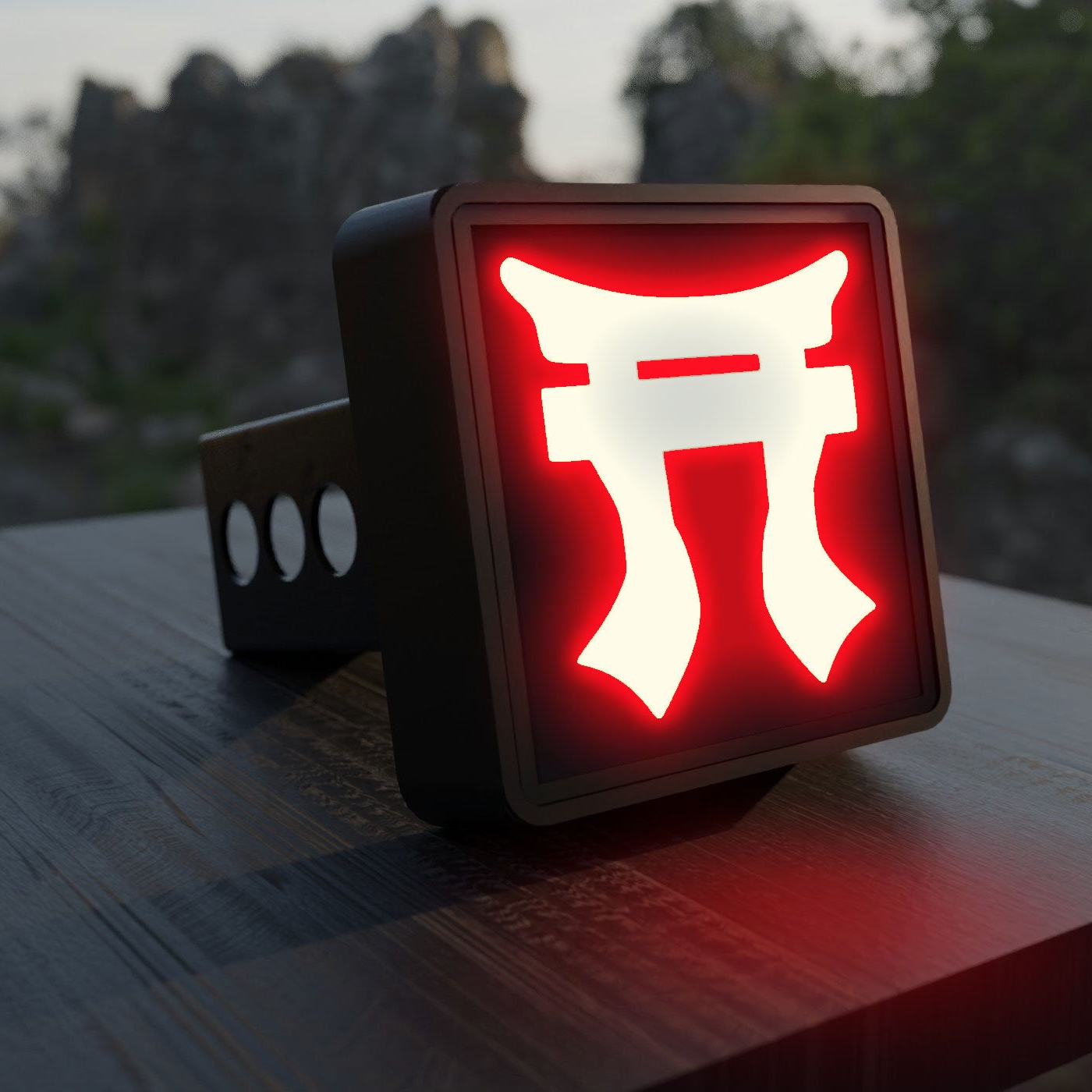 A red neon sign with a white symbol is displayed on a wooden surface, with a blurred natural background.
