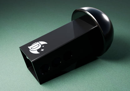 a close up of a black box on a green surface