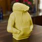 a yellow toy sitting on top of a wooden table