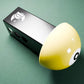 a yellow and black object on a green surface