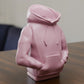 a pink statue of a person sitting at a table