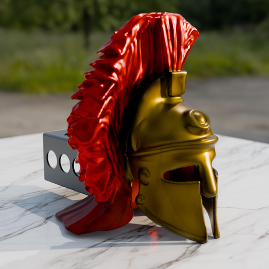 A golden helmet with a red plume is displayed on a marble surface, with a blurred background suggesting an outdoor setting.