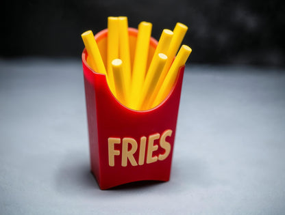 a red box filled with fries sitting on top of a table