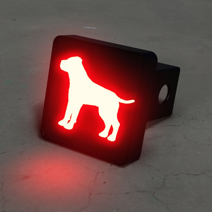 a red dog sign sitting on top of a cement floor