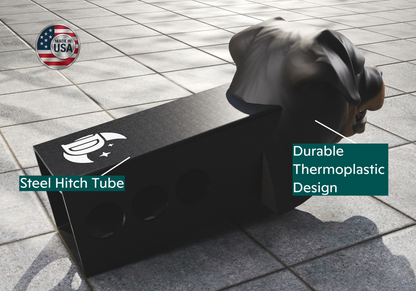 a person sitting on the ground next to a black box