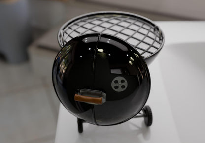 A small black barbecue grill with a metal grate and a handle on the front.