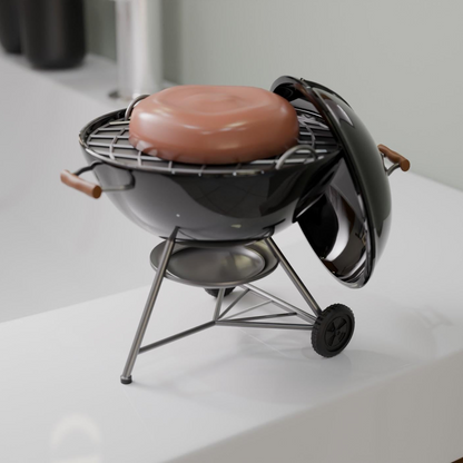 A small black grill with a red object on top, placed on a white surface.