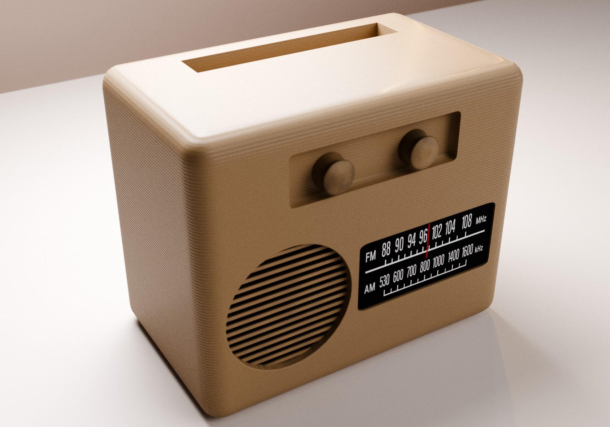 A tan-colored vintage radio with a speaker and two knobs, sitting on a white surface.