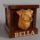 a wooden carved picture of a dog in a box