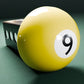 a yellow pool ball sitting on top of a green table