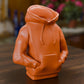 a small orange toy sitting on top of a wooden table