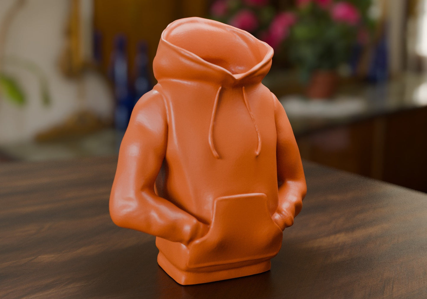 a small orange toy sitting on top of a wooden table