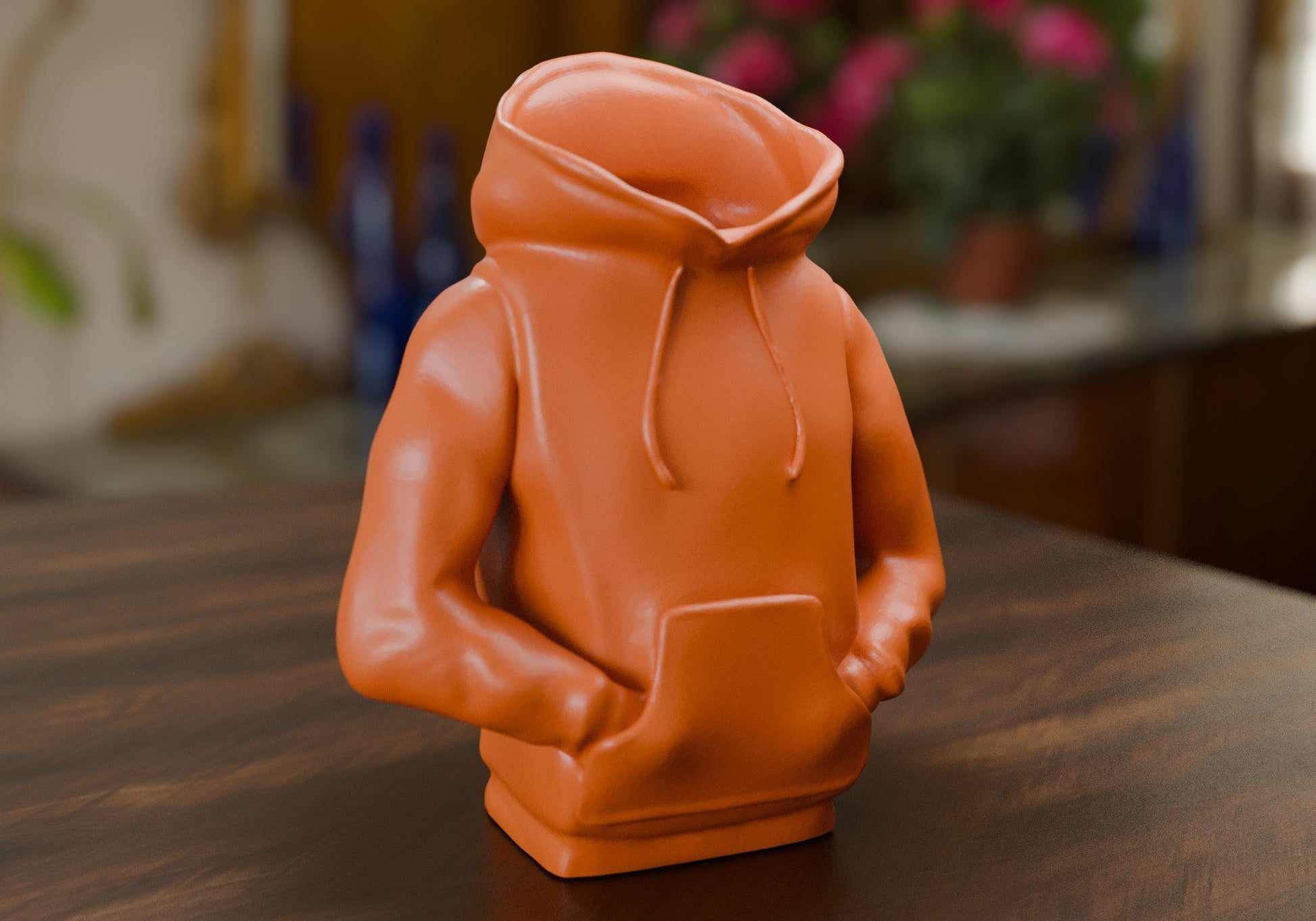 a small orange toy sitting on top of a wooden table