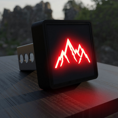 A square-shaped object with a red mountain symbol on it, placed on a wooden surface.