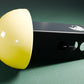 a yellow and black object on a green surface