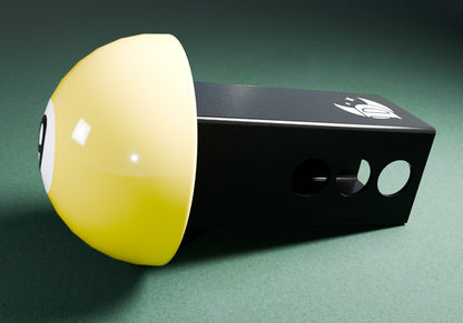 a yellow and black object on a green surface
