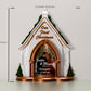 a christmas ornament with a picture of a couple in a church