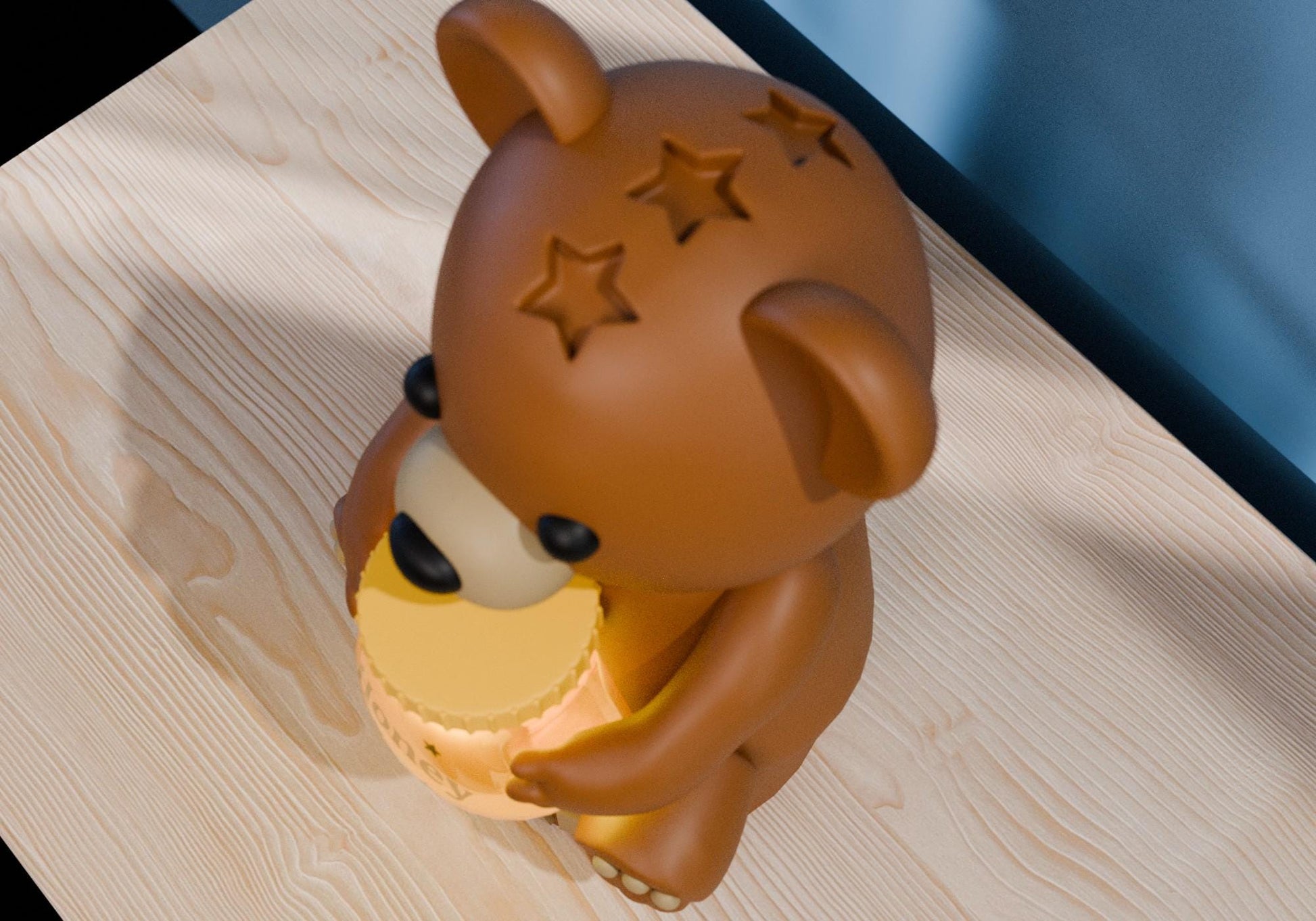 a brown bear figurine sitting on top of a wooden table