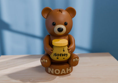 a brown teddy bear sitting on top of a wooden table
