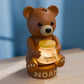 a brown bear sitting on top of a wooden table