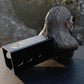 a statue of a man with a box on a table