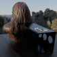 a black object with a long hair sitting on a table