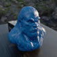 a blue gorilla head sitting on top of a wooden table
