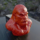 a red gorilla head sitting on top of a wooden table