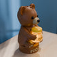 a brown bear sitting on top of a wooden table