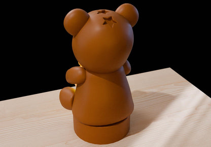 a brown bear statue sitting on top of a wooden table