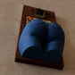 a blue couch sitting on top of a wooden block