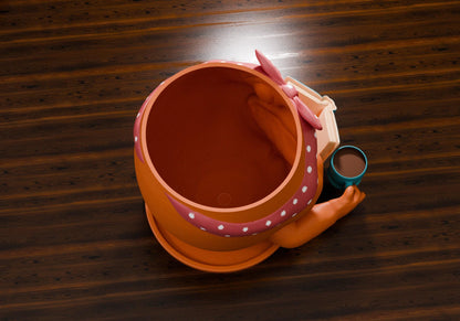 an orange hat with polka dots and a pair of scissors