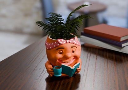 a planter with a potted plant and a book on a table