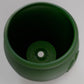 a close up of a green cup on a table