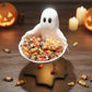 A Halloween-themed scene featuring a ghost figurine holding a bowl of candy, surrounded by carved jack-o-lanterns and lit candles.