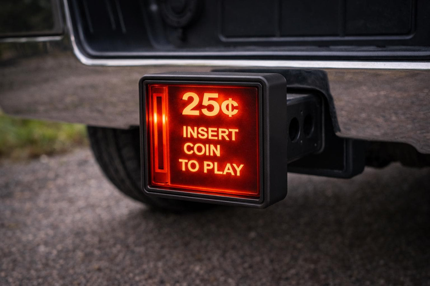 A red sign attached to a vehicle, displaying the message "INSERT COIN TO PLAY" in white text.