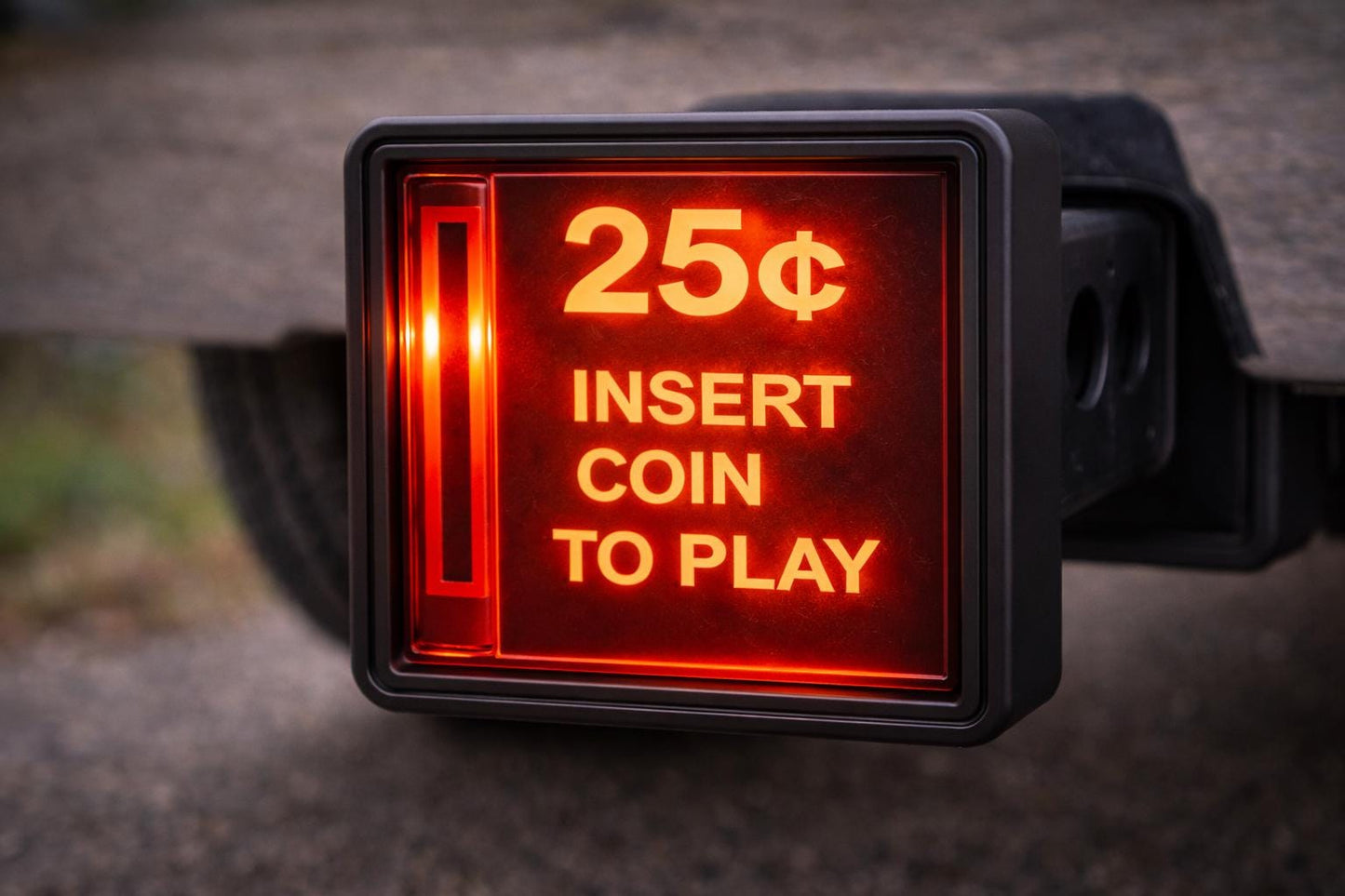 A red sign with the text "25¢ INSERT COIN TO PLAY" illuminated, indicating that a 25-cent coin is required to play a game or purchase a game.