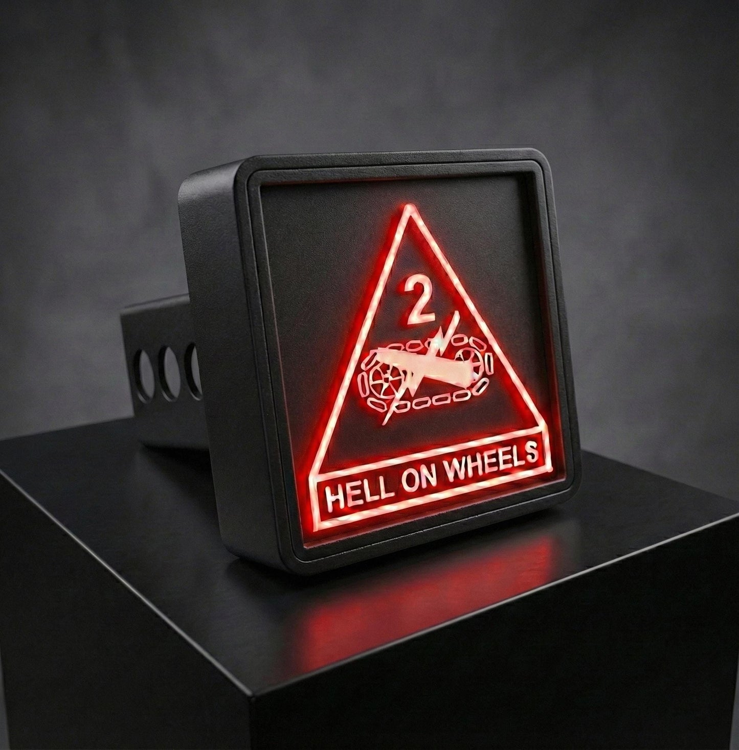 A black rectangular sign with a red triangle and the text "HELL ON WHEELS" displayed on it.