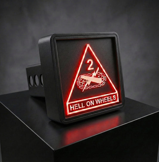 A black rectangular sign with a red triangle and the text "HELL ON WHEELS" displayed on it.