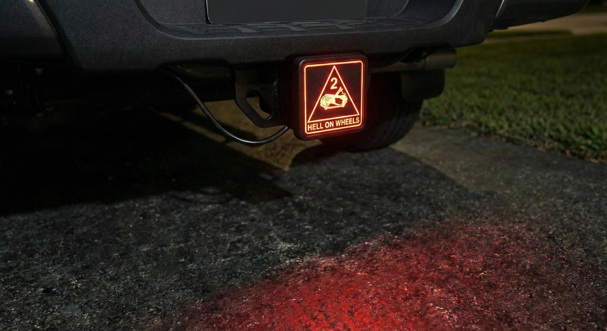 a warning sign on a vehicle indicating that the vehicle has 2 wheels, with a red light below the sign.