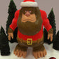 a plastic figurine of a bear wearing a santa hat